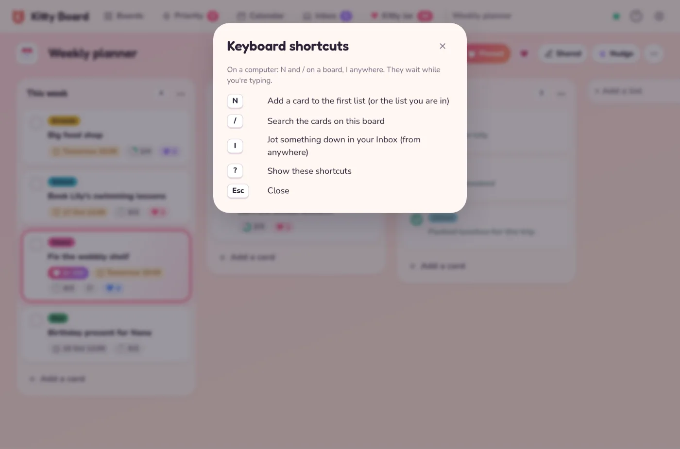 The Keyboard shortcuts sheet over the Weekly planner board: N adds a card, / searches the board, I jots in your Inbox, ? shows the shortcuts and Esc closes